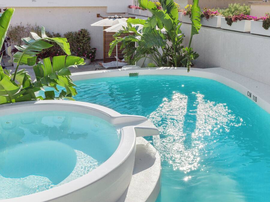 Seasonal outdoor pool, open 11:00 AM to 7:00 PM, pool umbrellas