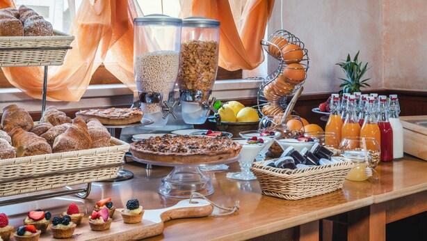 A breakfast buffet with various pastries, fruits, and beverages. - Hotel La Fenice (Castel di Sangro)