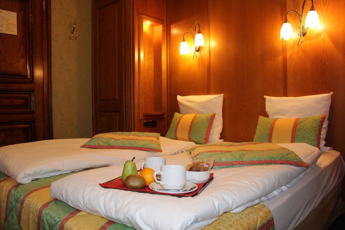 Ein Hotelzimmer mit einem großen Bett, Holzwänden und zwei Wandleuchten.