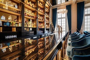Una zona de bar con estantes llenos de botellas de licor, una barra pulida y filas de sillas tapizadas en azul.