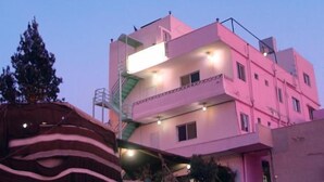 A multi-story building with balconies and exterior lighting. - Valentine Inn (Wadi Musa)