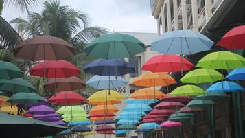A street with colorful umbrellas hanging overhead.