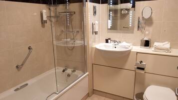 A modern bathroom with a glass-enclosed shower, a standalone bathtub, a sink with a vanity, and a toilet.