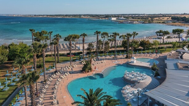 A resort with a large pool, beach, and ocean views. - Blu Salento Village (Nardò)