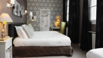 A bedroom with a large bed, a bedside table with a lamp, a mirror, a dresser, and a window with curtains.