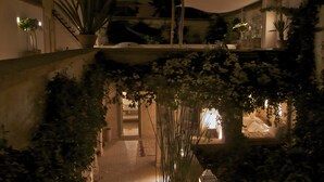 Un jardín interior con macetas y un farol.