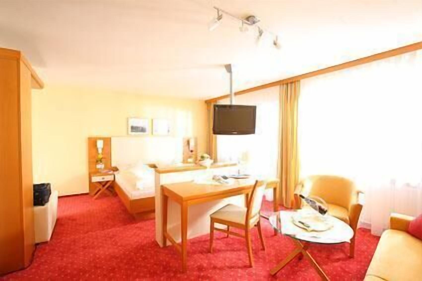premium double room | living area | flat-screen tv