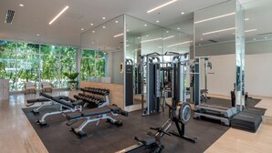 A modern gym with various exercise equipment, large windows, and a clean, spacious layout. - Hotel Arena Blanca (San Andrés)