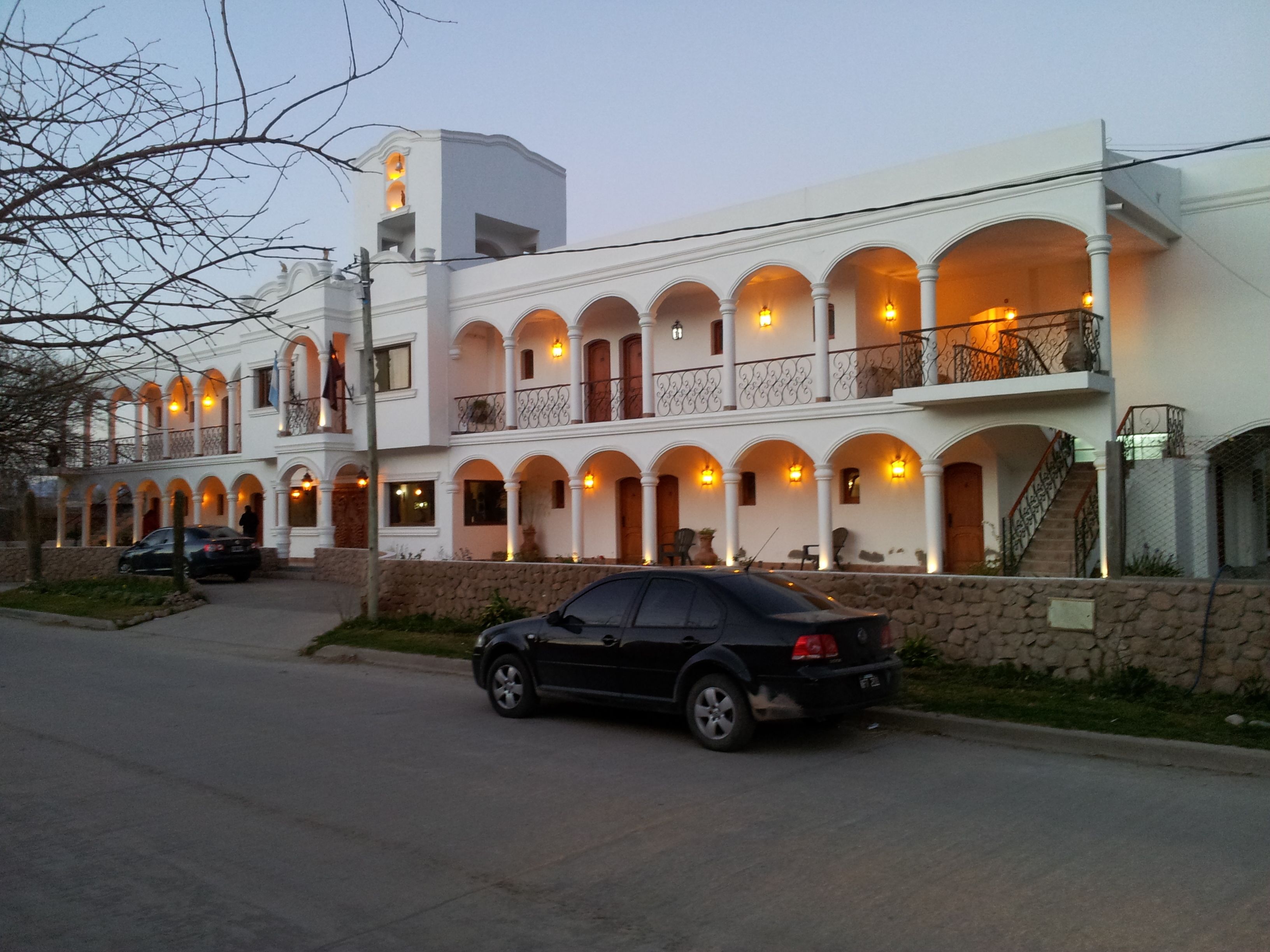 A multi-story building with a series of balconies and arched windows.