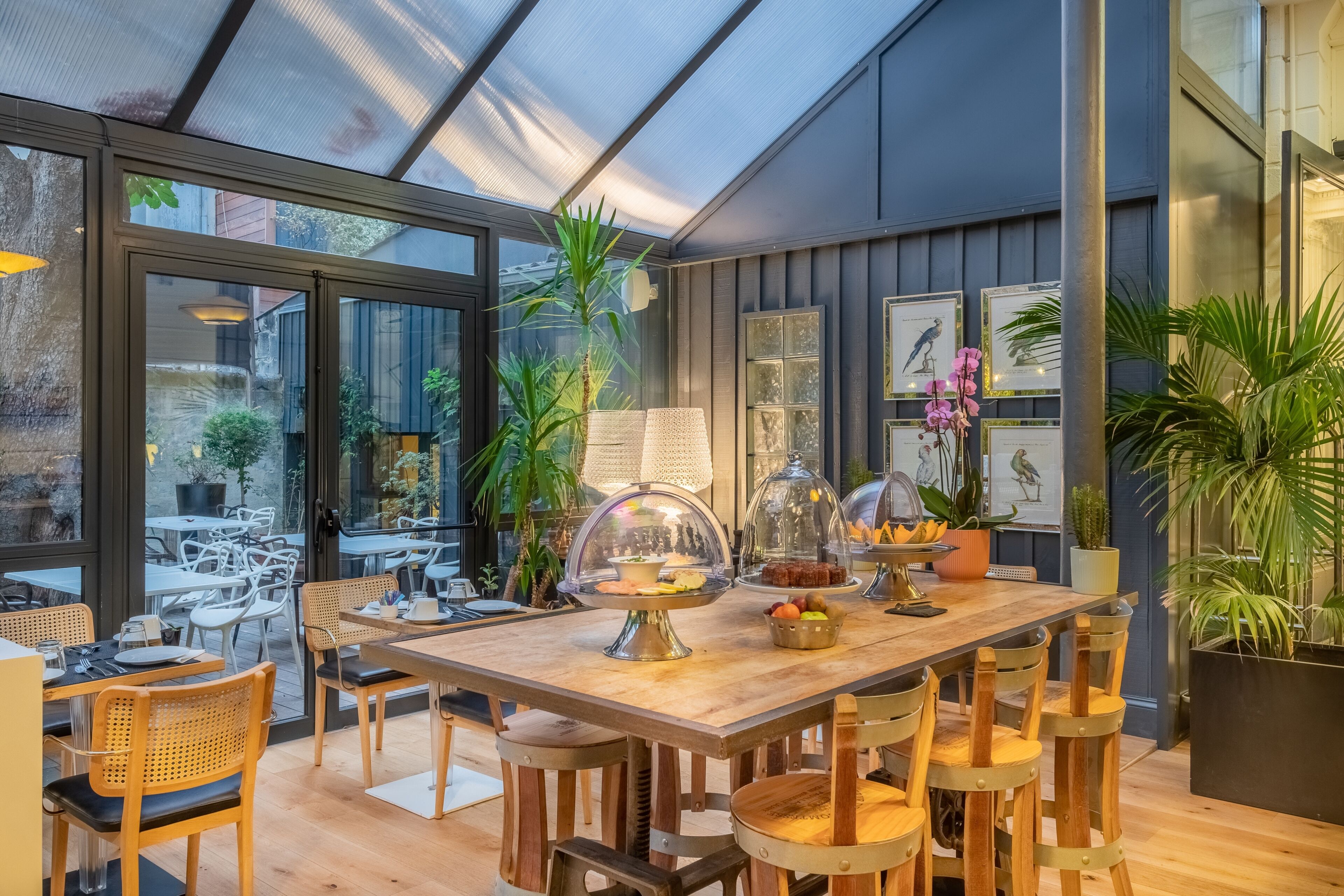 An indoor dining area with a wooden table, chairs, and a glass enclosure displaying food.