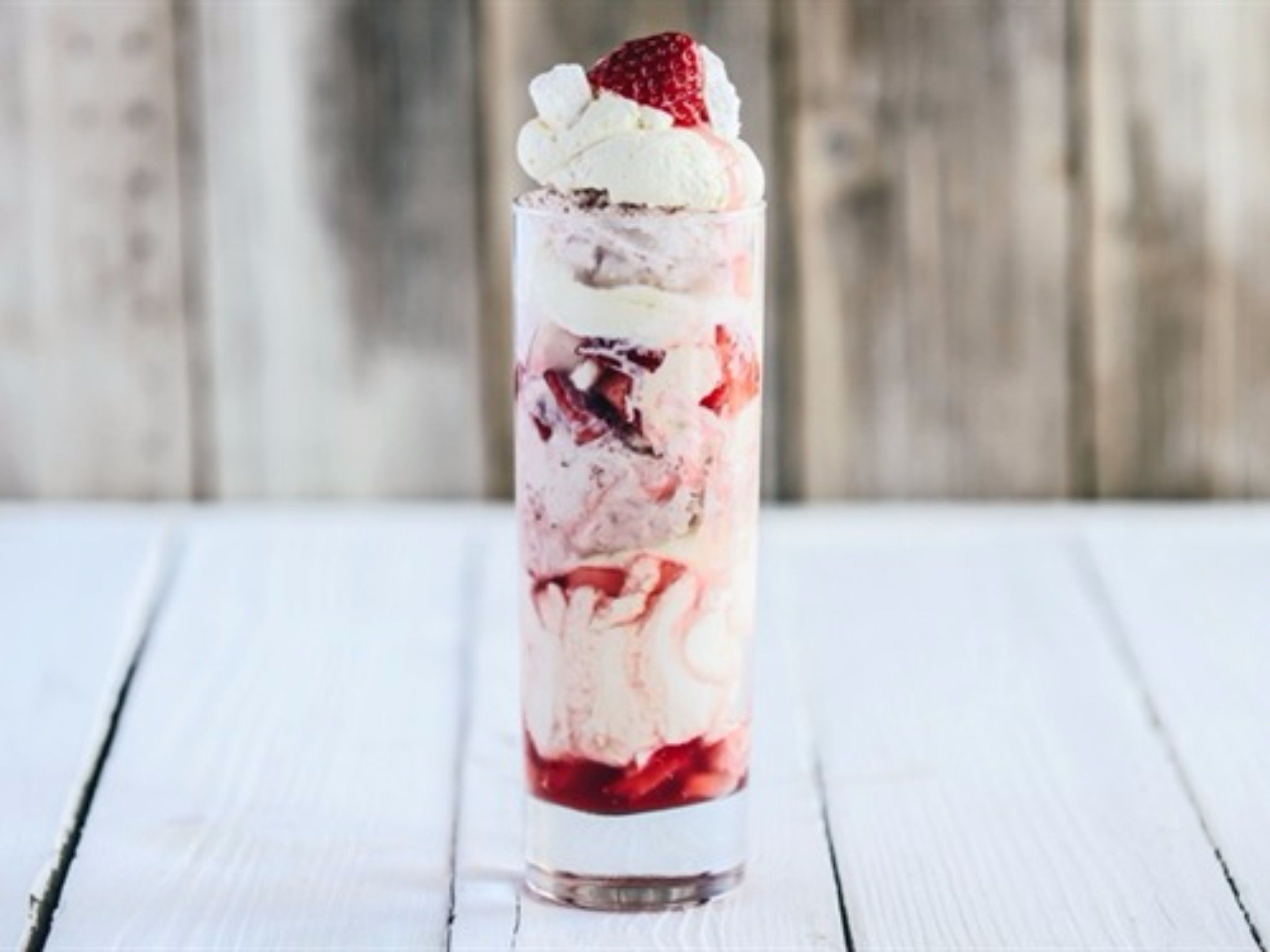 Un postre en capas dentro de un vaso transparente.