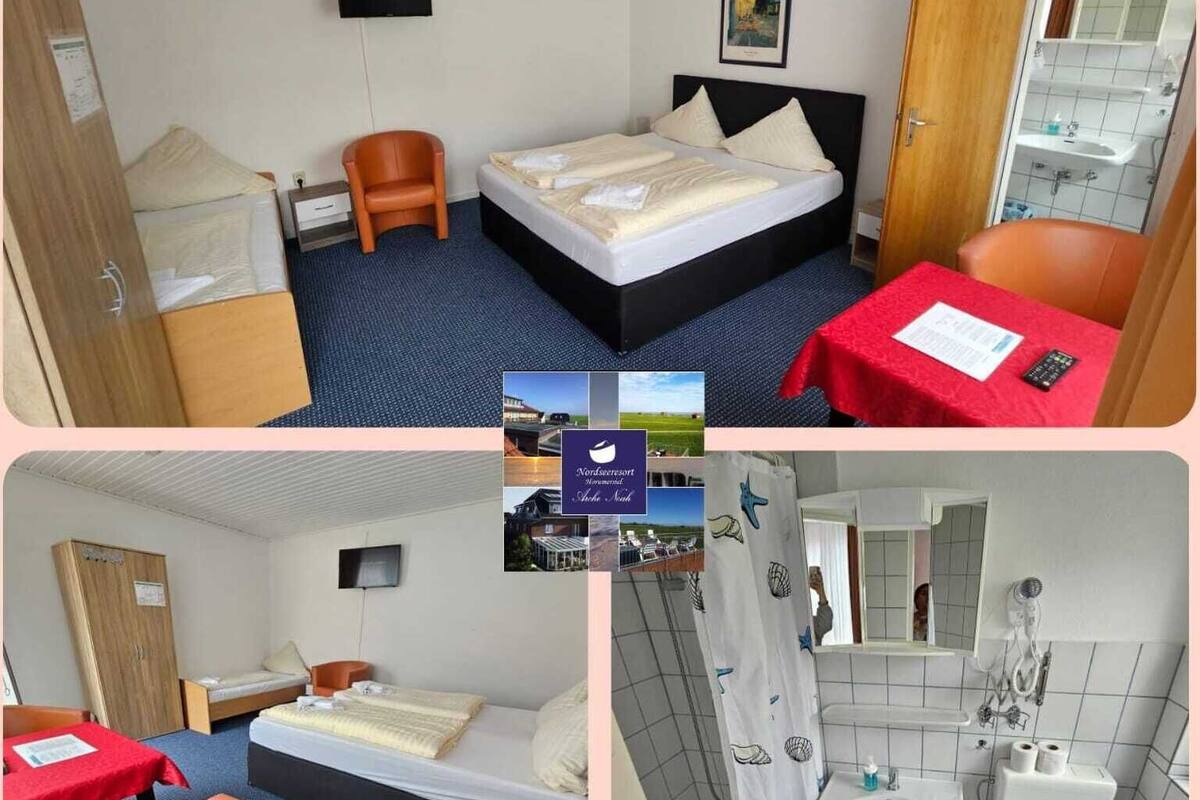 A hotel room with a bed, a desk, a chair, a wardrobe, and a bathroom with a sink and toilet.