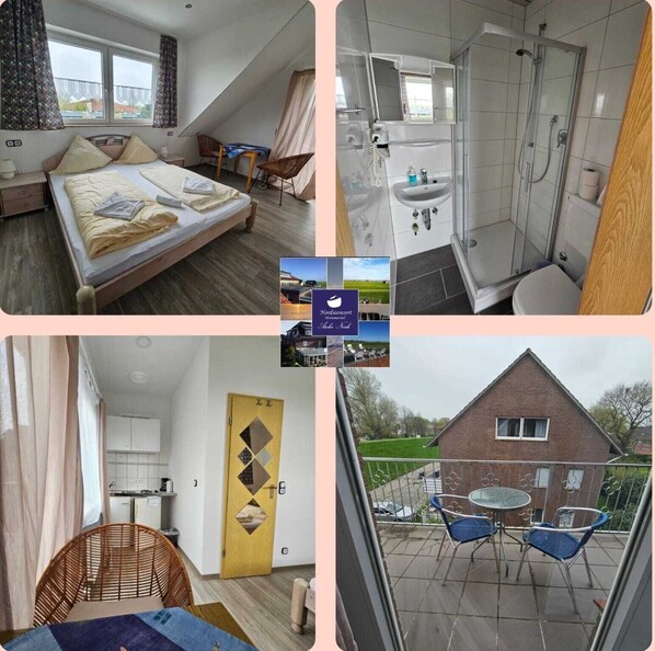 A bedroom with a bed, a bathroom with a shower and sink, a kitchen with cabinets, and a balcony with chairs. - Hotel Arche Noah (Wangerland)