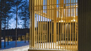 A modern building with a wooden exterior and a large open window area. - Anttolanhovi (Mikkeli)