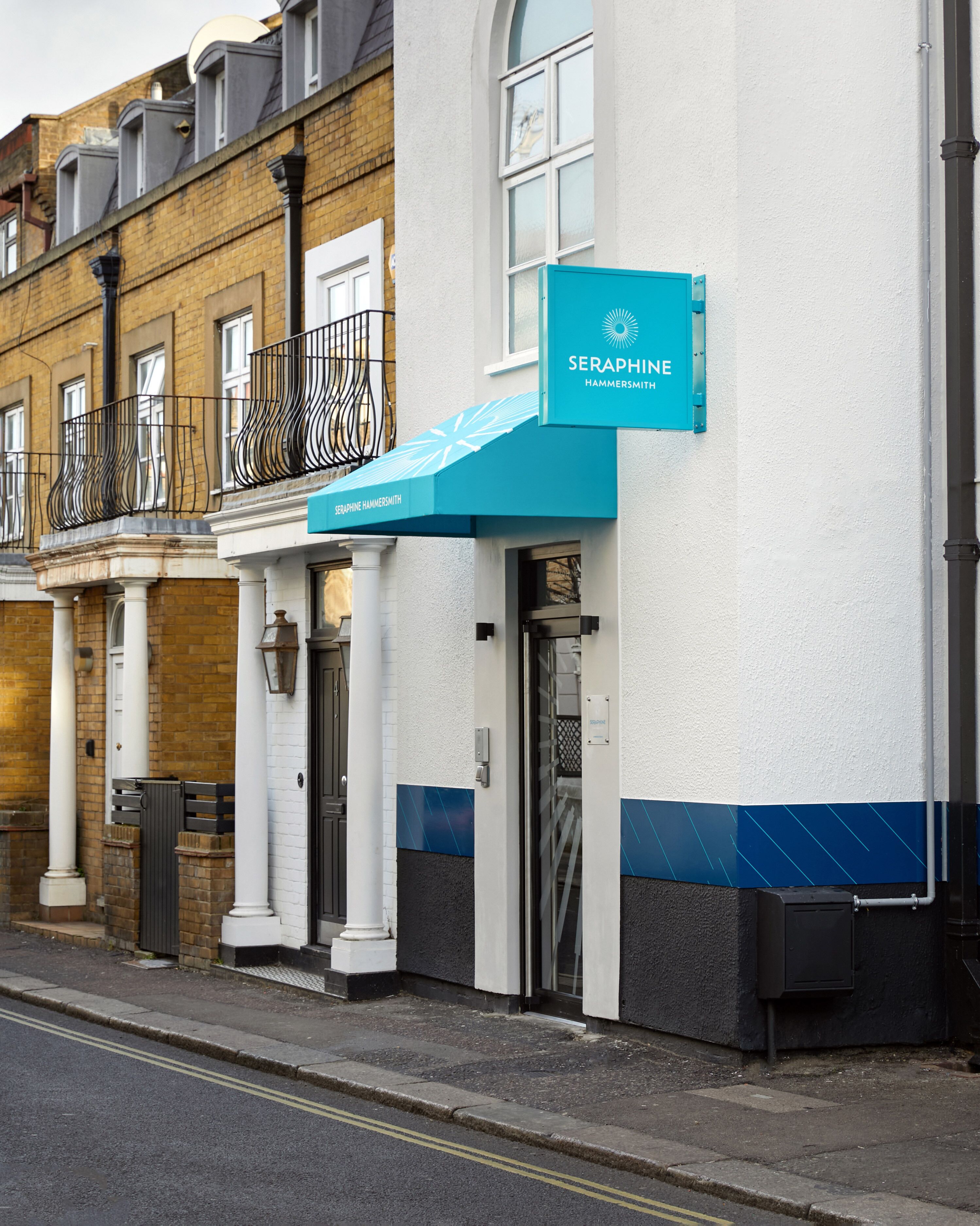 A building with a blue awning and a sign that reads "SERAPHINE HAMMERSMITH."