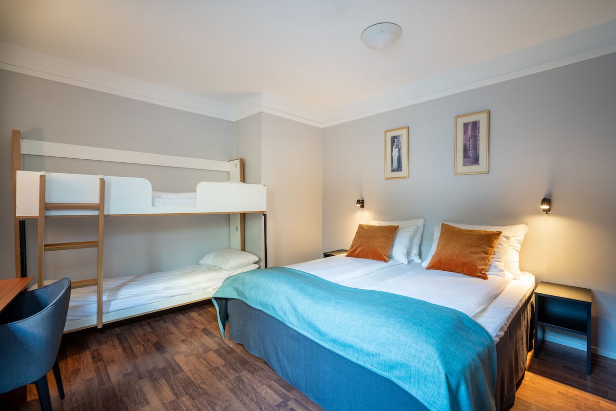 Family Room | Hypo-allergenic bedding, desk, laptop workspace, iron/ironing board
