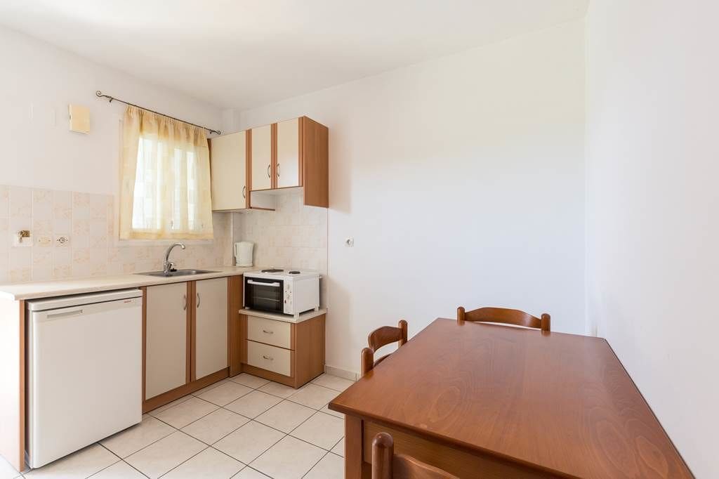 apartment, 1 bedroom, kitchen, pool view | private kitchen | fridge, stovetop, electric kettle, cookware/dishes/utensils