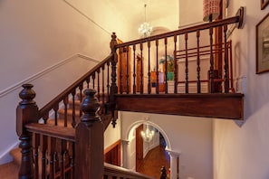 Stunning staircase with classic design, featuring a handrail and leading to an upper level.