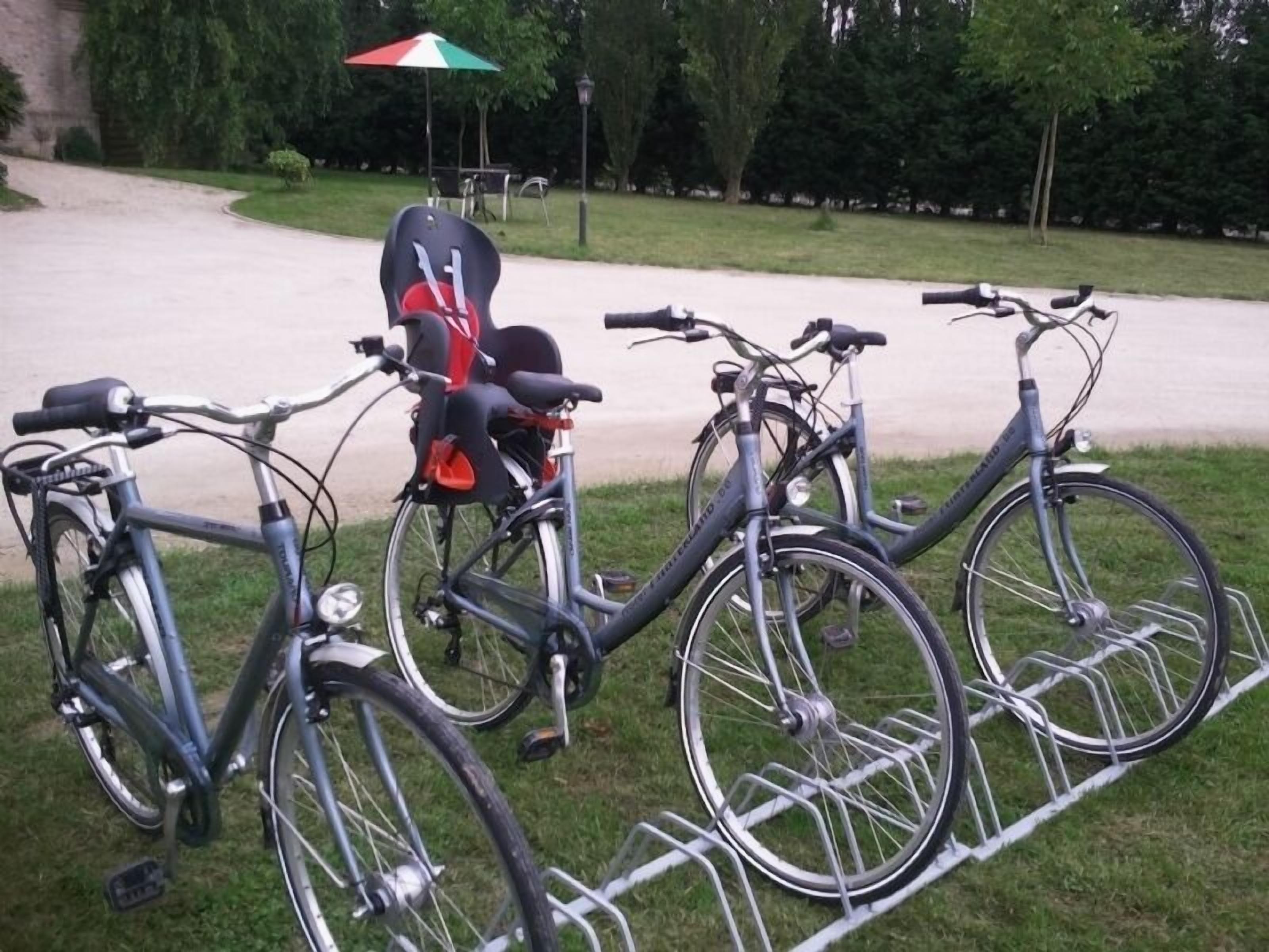 A bicycle rack with two bicycles parked on it.