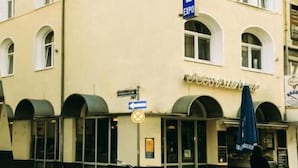 A hotel with a prominent 'HOTEL' sign, multiple windows, and a sign for 'Café Restaurant'. - Hotel Expo Frankfurt City Centre - Digital Check-In (Frankfurt)