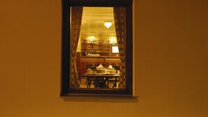 A café named 'café kriva' with a window displaying the interior. - Pension Krivá (Olomouc)