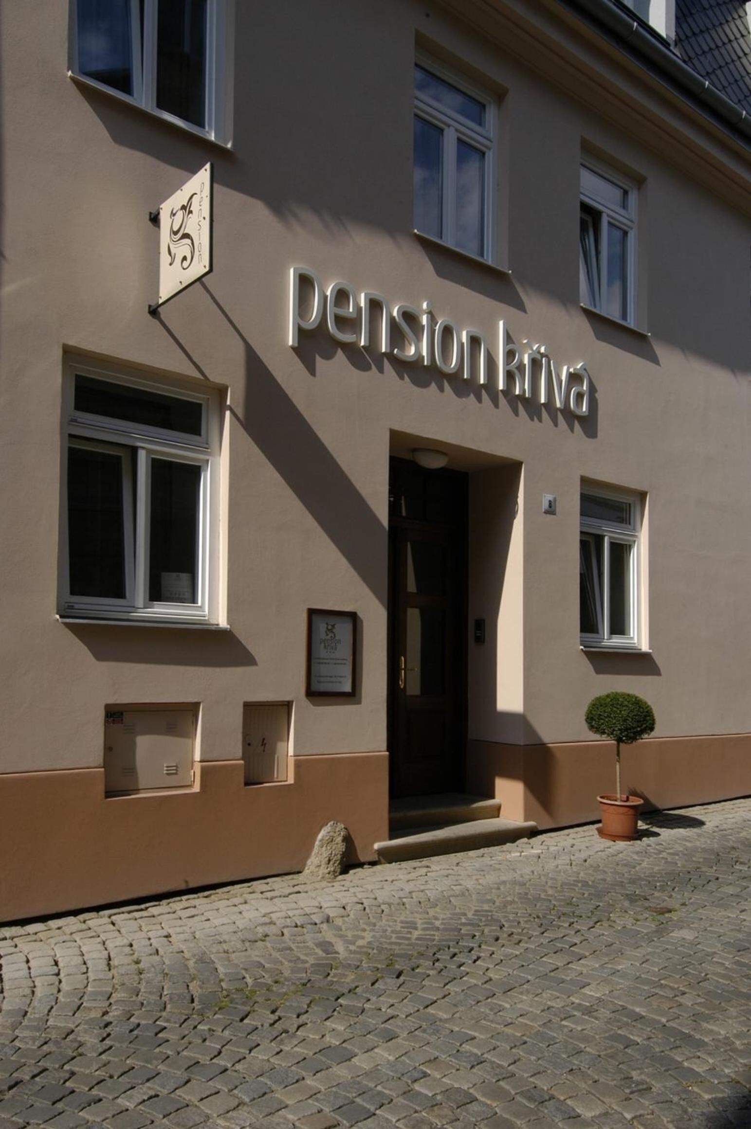 A building with the sign "pensionkiva" indicating it is a pension home.