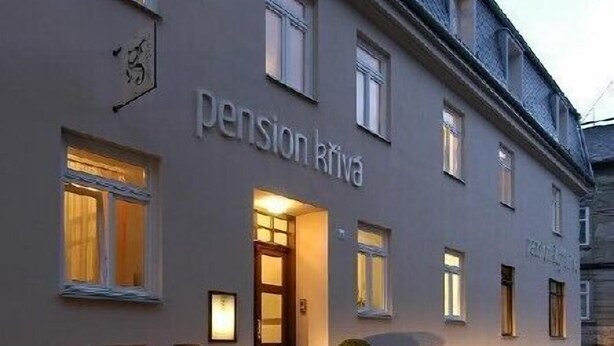 A building with the sign "pension Kriva" on the facade, featuring a traditional European architectural style with a cobblestone street in front. - Pension Krivá (Olomouc)