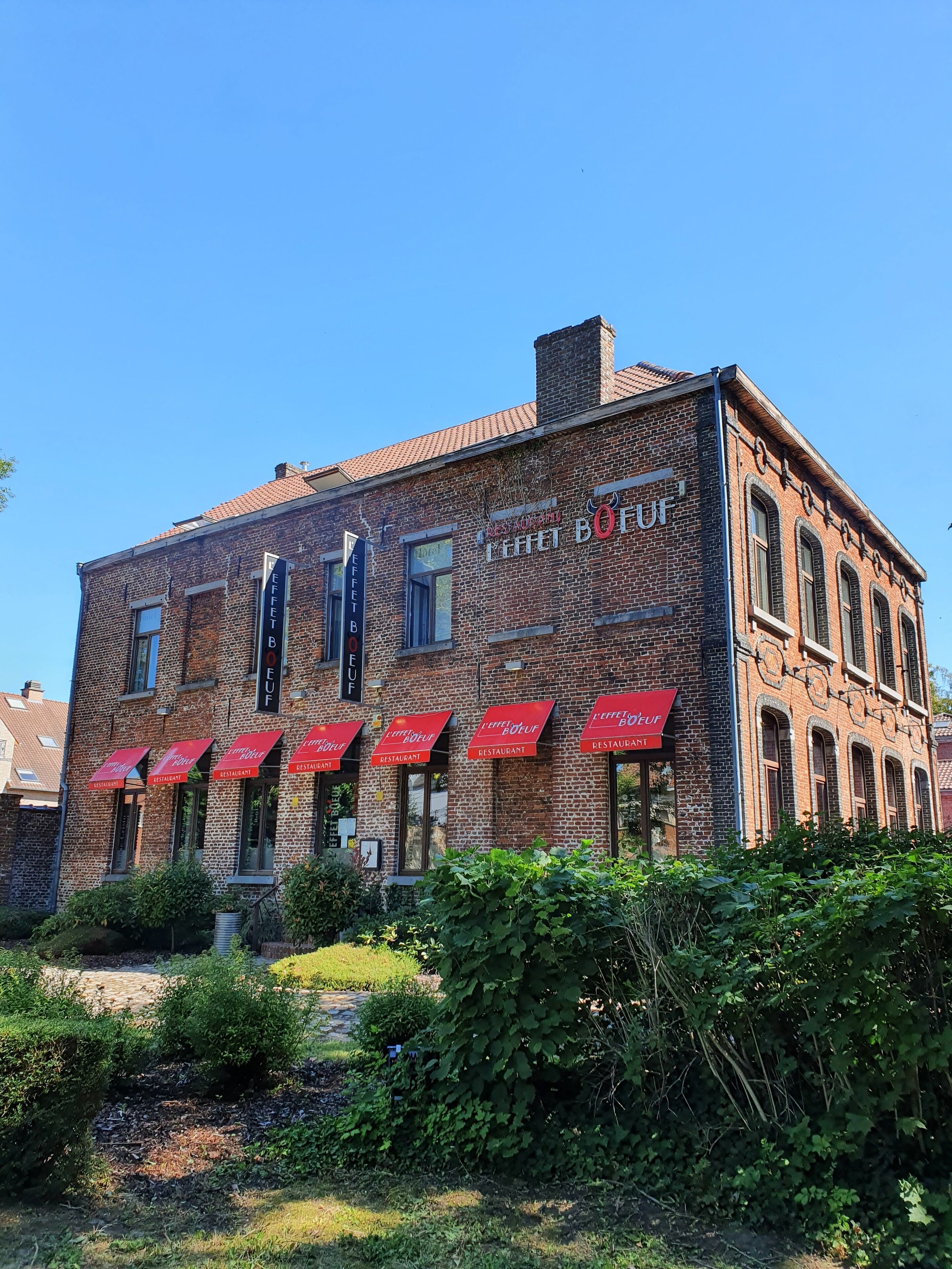 A brick building with multiple red awnings labeled "Leffet Bueuf Restaurant."