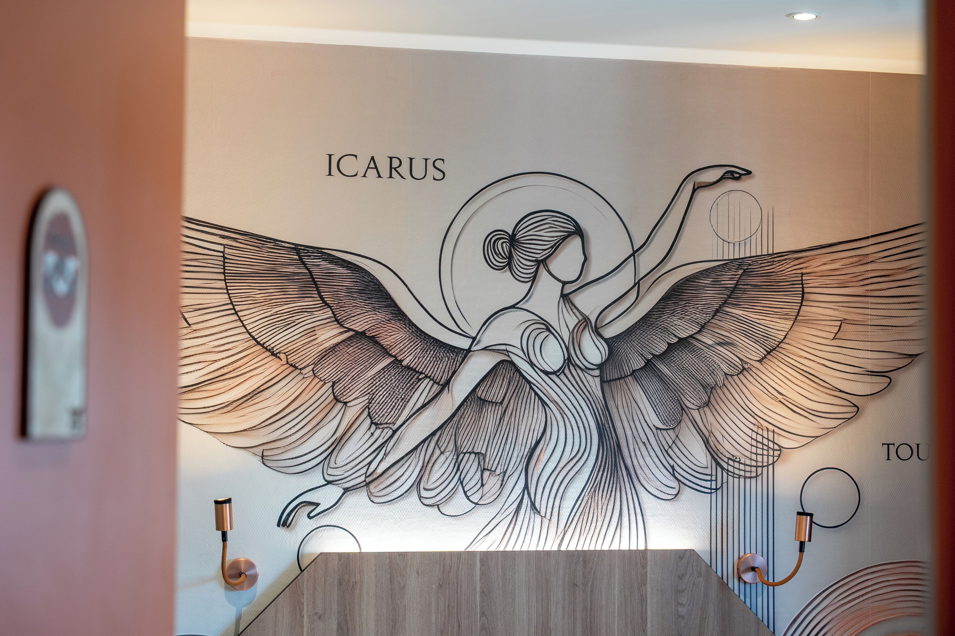 A wall mural with an angelic figure and the word 'ICARUS' visible.