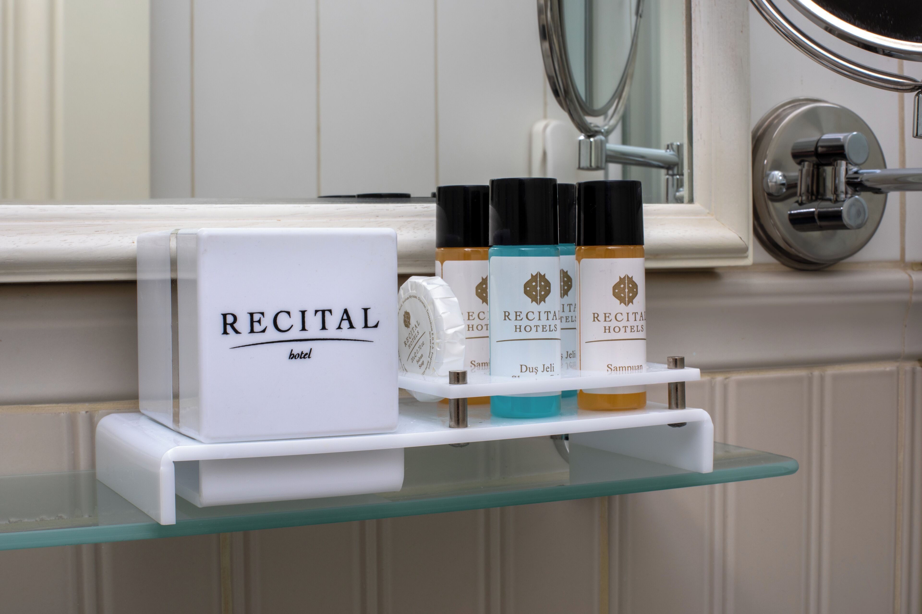 designer toiletries, hair dryer, slippers, towels