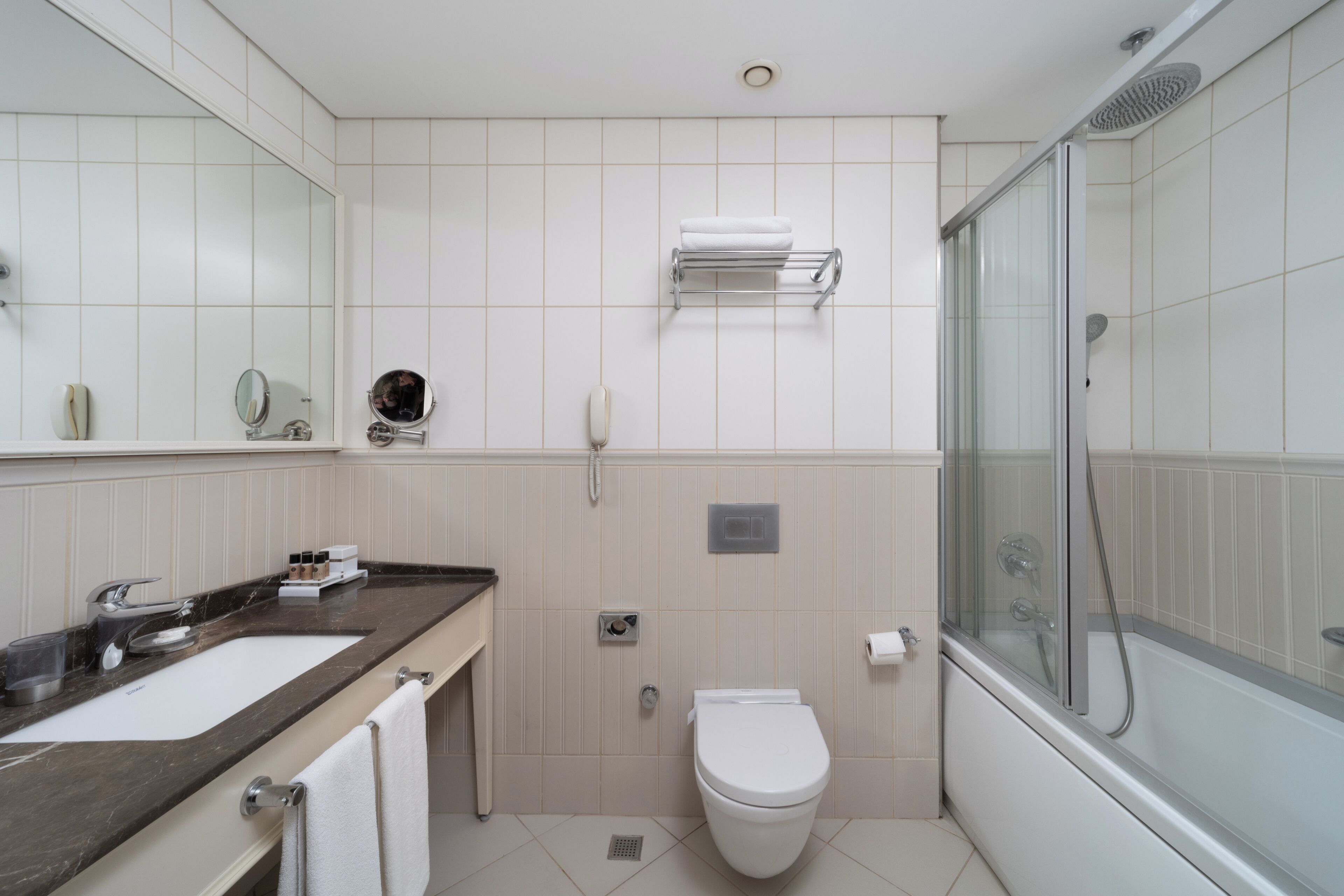 designer toiletries, hair dryer, slippers, towels