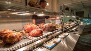 A buffet with various meats displayed in a glass case. - The Lugger Inn (Penzance)