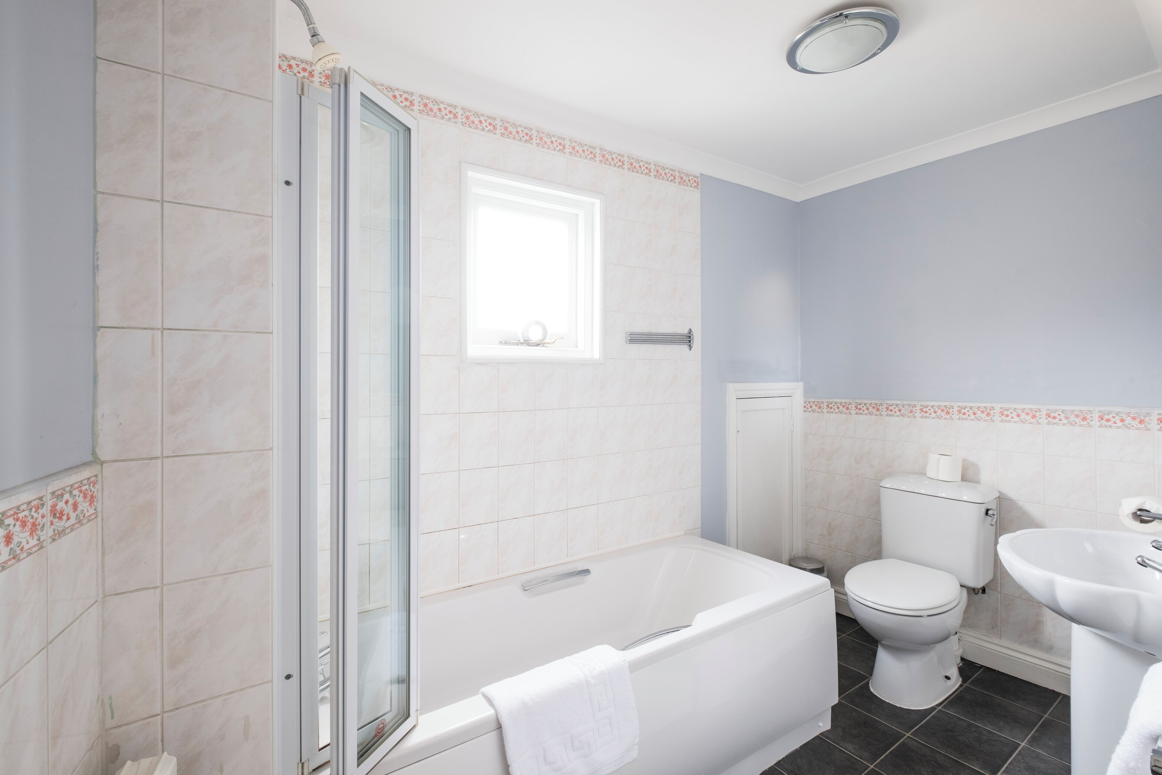 A bathroom with a bathtub, toilet, and sink.