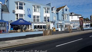 A coastal building with multiple windows and a blue facade, likely a hotel or restaurant. - The Lugger Inn (Penzance)