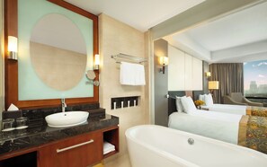 A hotel bathroom with a large mirror, a bathtub, a sink, and a towel rack. - Crowne Plaza West Hanoi Residences (Hanoi)