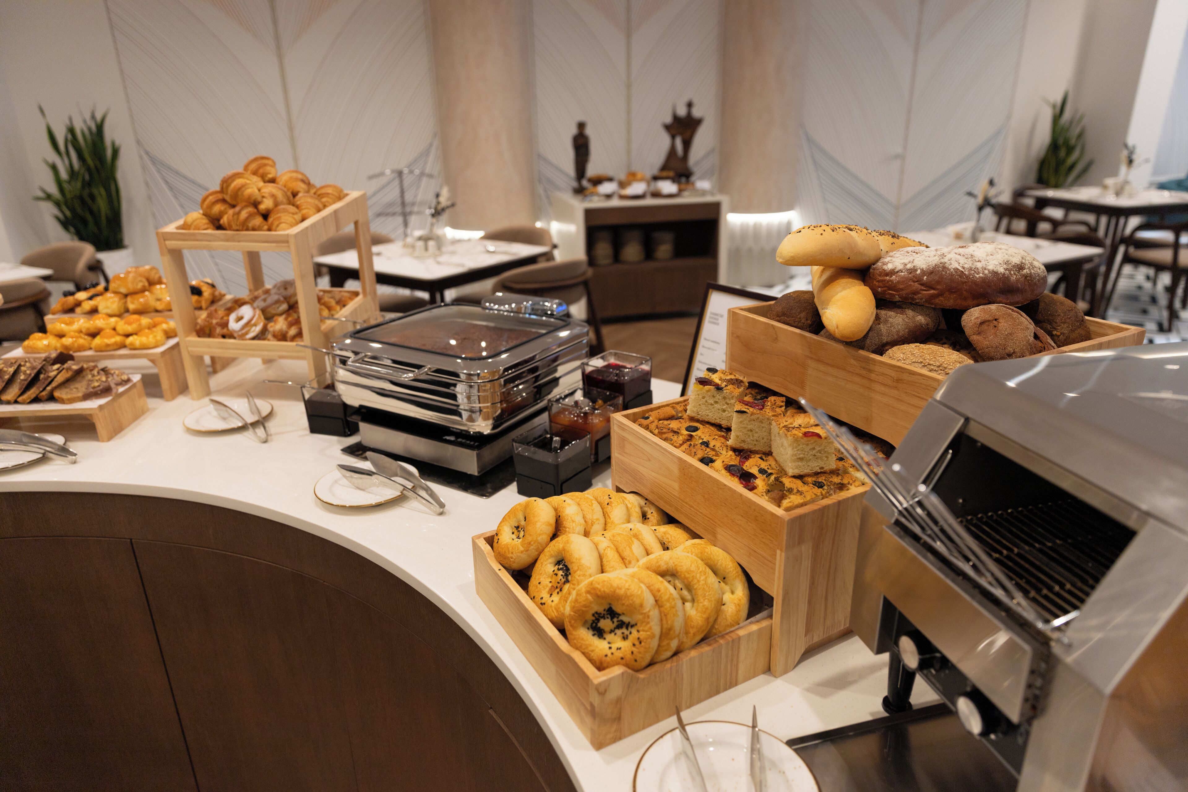 A buffet with various baked goods and a coffee machine.