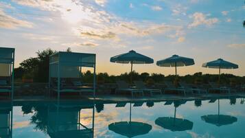 Alberca al aire libre por temporada y sombrillas en la alberca
