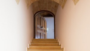 A staircase with a stone archway leading to a door. - Aktaion Hotel (Monemvasia)