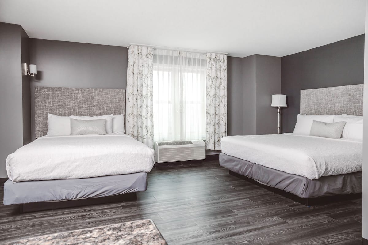 Premium bedding, desk, laptop workspace, blackout drapes