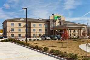 A Holiday Inn Express hotel with a parking lot and a landscaped area.
