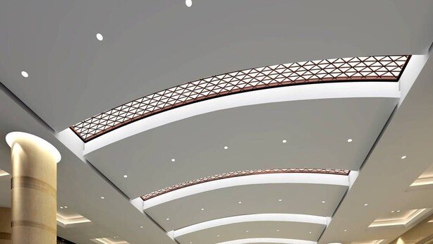 A modern indoor swimming pool with a curved ceiling, large pillars, and a wall with a geometric pattern. - Triumphal View Hotel (Dongguan)