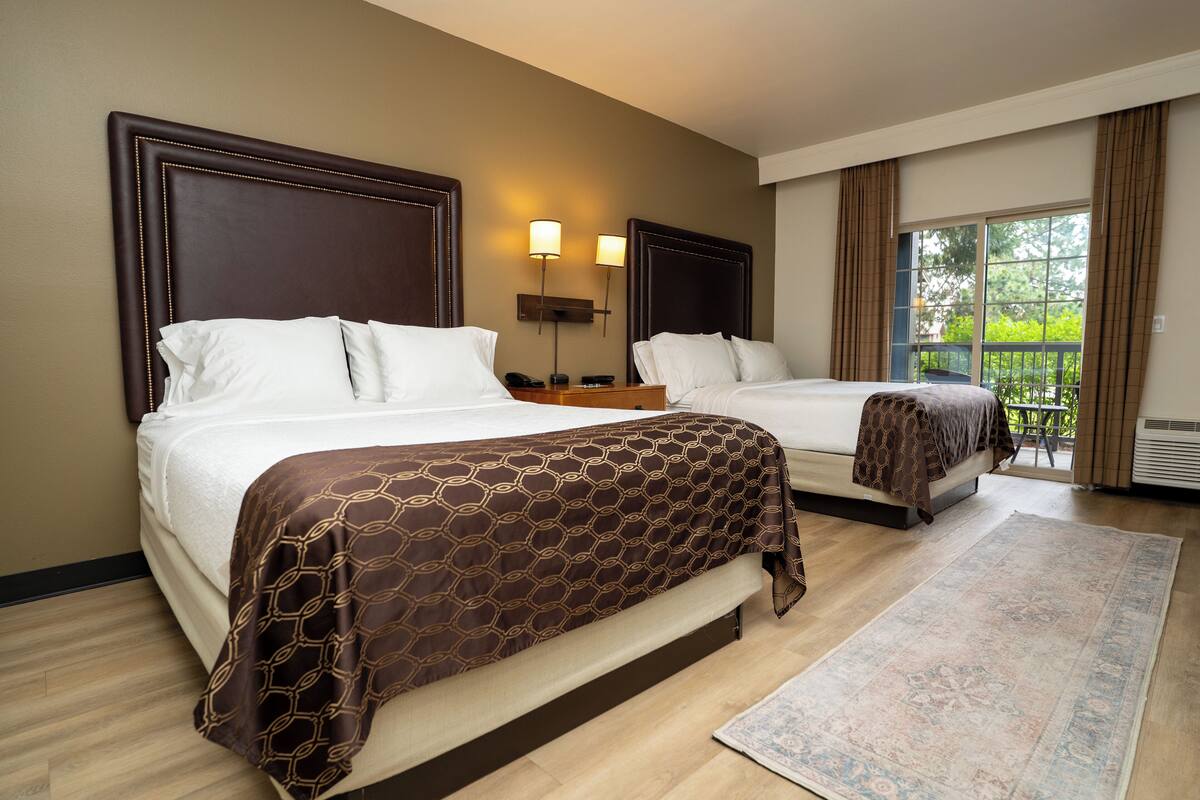 Deluxe Room, 2 Queen Beds (Village View - 2 Queen beds a deck) | Desk, iron/ironing board, bed sheets