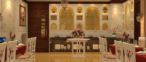 A dining area with white chairs, a round table, and a chandelier.