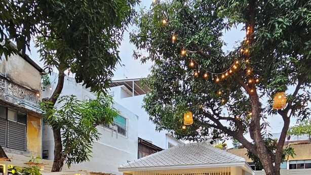 A serene outdoor area with a pool, seating, and a bar area. - Feung Nakorn Balcony Rooms and Cafe (Bangkok)