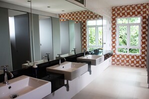 A modern bathroom with three sinks, large mirrors, and a window with a geometric tile pattern. - Feung Nakorn Balcony Rooms and Cafe (Bangkok)