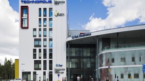 A modern building with multiple signs, including "Technopolis" and "Norlandia Care Tampere Hotel".