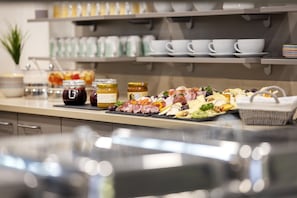 A buffet with various food items and condiments.