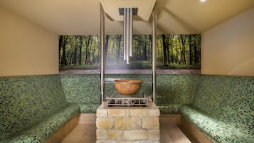 Cozy retreat with a stone fireplace, green mosaic wall, and cushioned bench.