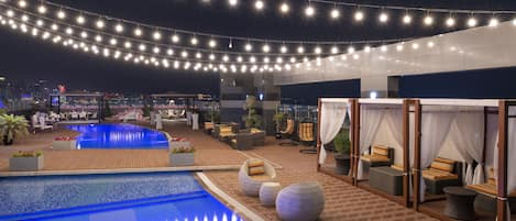 2 utendørsbassenger og solsenger