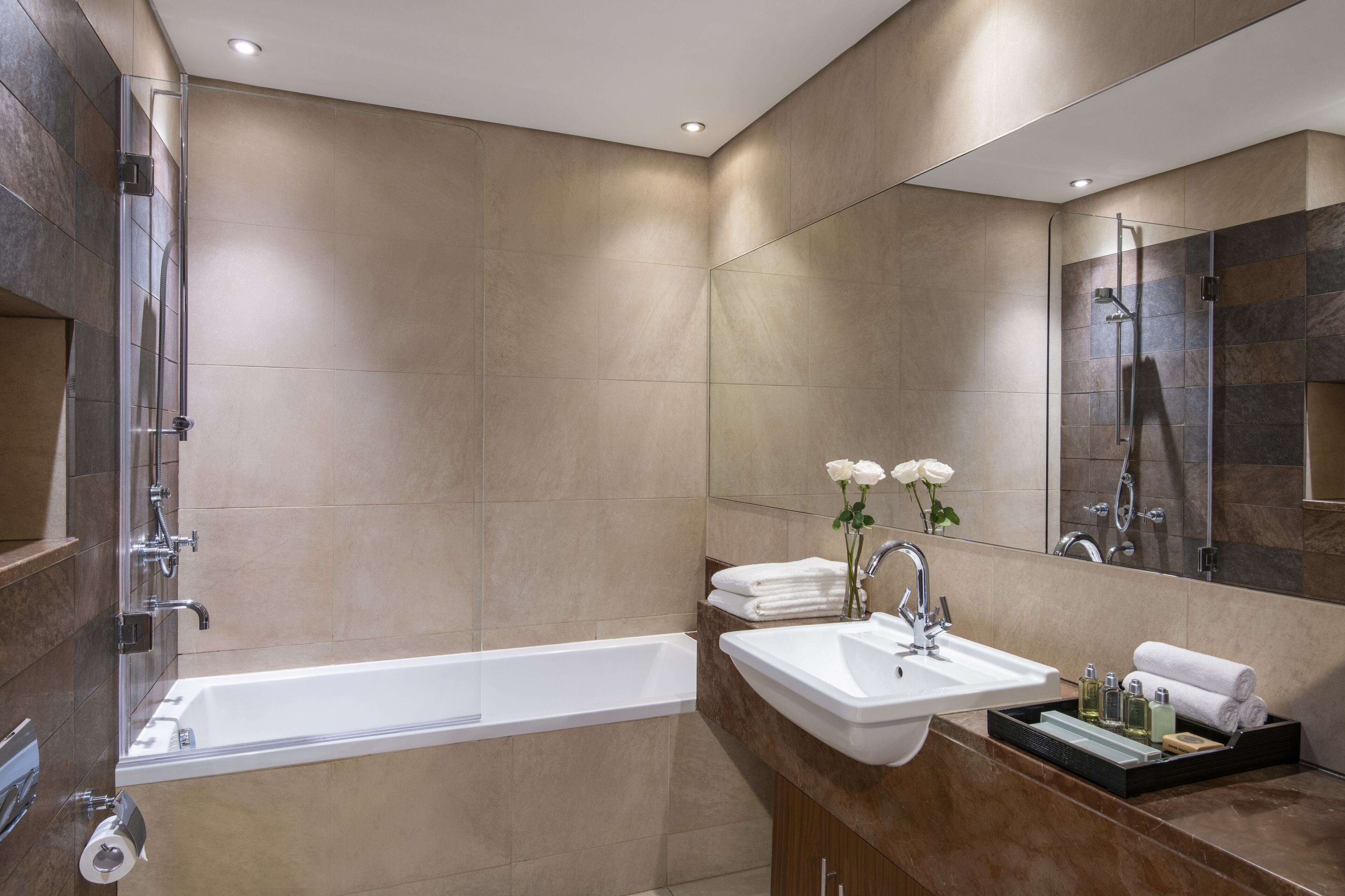 Un baño moderno con bañera, lavamanos y ducha.